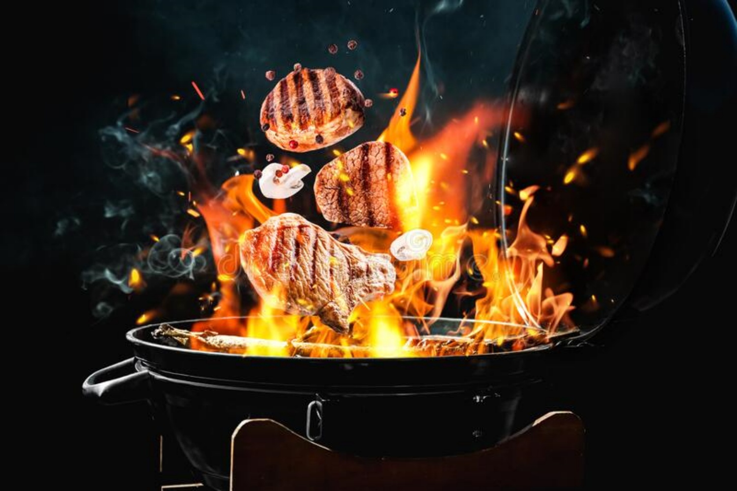 13.meat-mushrooms-falling-onto-barbecue-grill-flame-against-black-background-closeup-meat-mushrooms-falling-onto-191721098